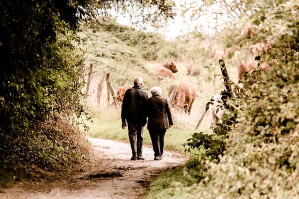 aging couple walking on a path