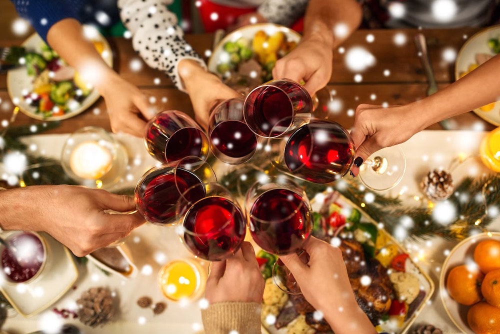 people at an empty nest Christmas party clinking wine glasses