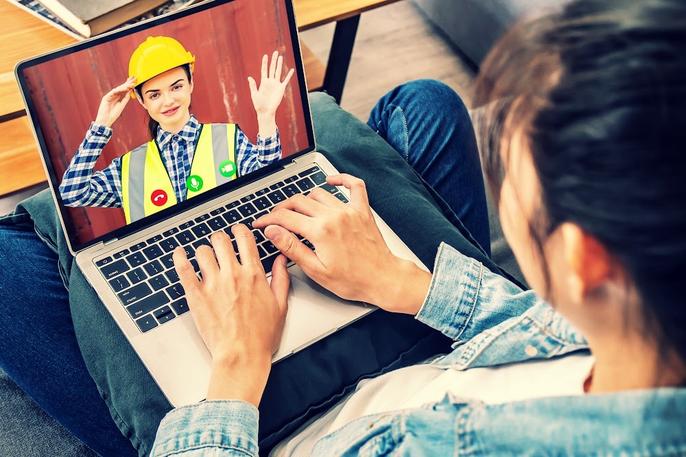 woman calling an expert in home maintenance and repairs on her laptop
