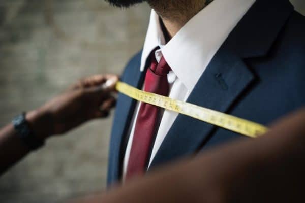 son being measured for a suit