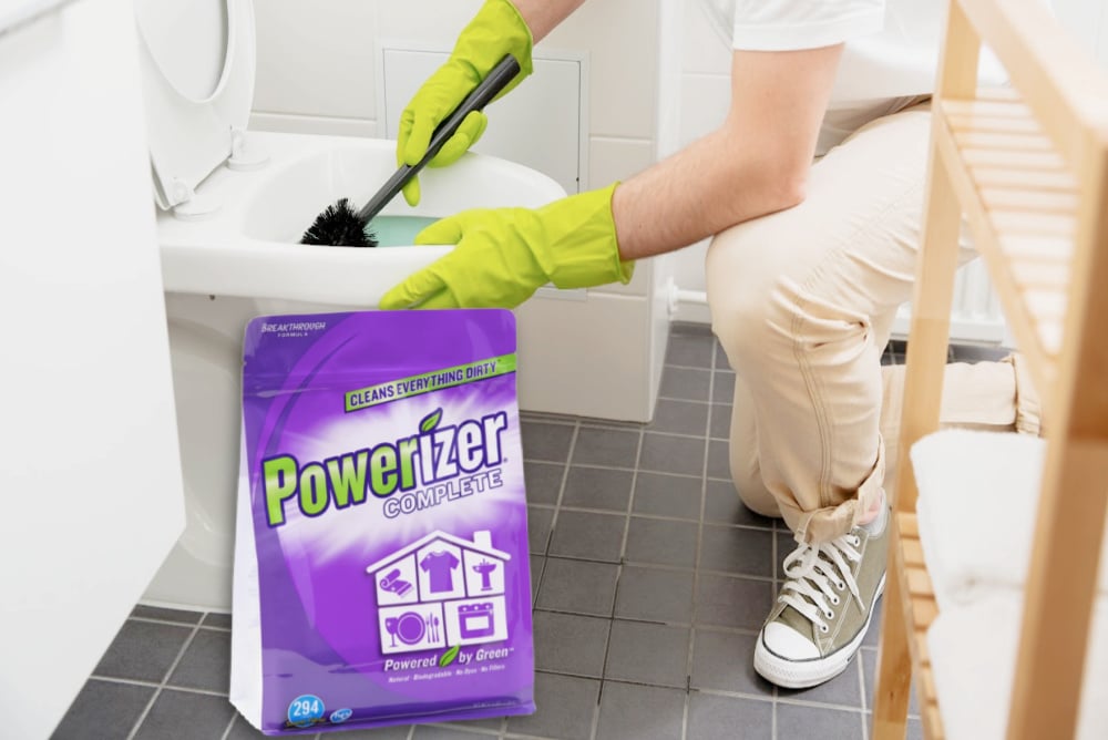man cleaning a toilet in a bathroom using Powerizer