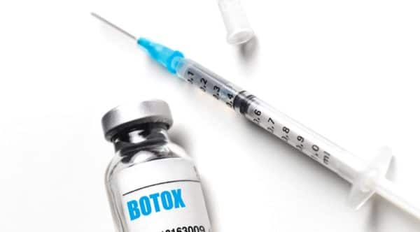 a bottle of botox and a syringe