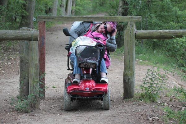 person in a power wheelchair on a hiking trail