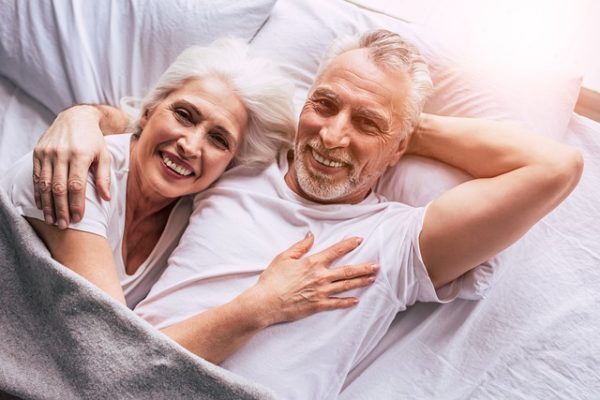 older couple cudding in bed