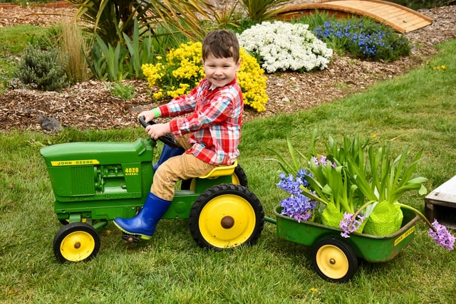 boy riding a toy tractor