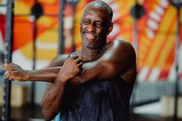 person stretching out shoulder