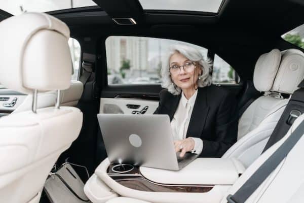 business woman over 50 sitting in a car