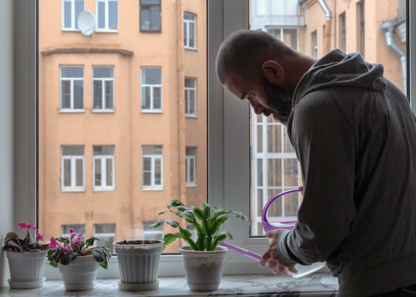 a depressed person looking out a window