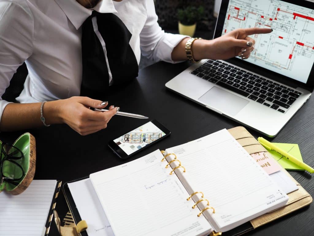 a business desk with calculator note books and financial papers