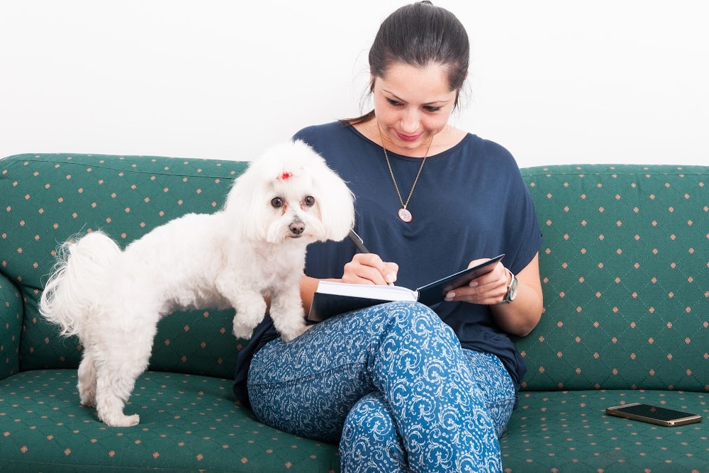 a woman over 40 journaling about her dog's personality