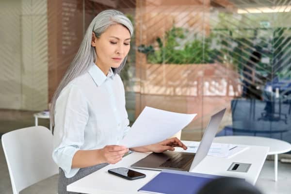 a woman over 40 looking and financial papers