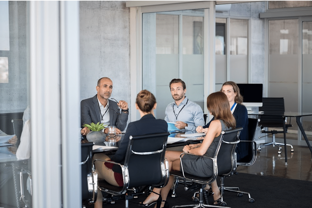 mena and women planning for a business events sitting at a conference table