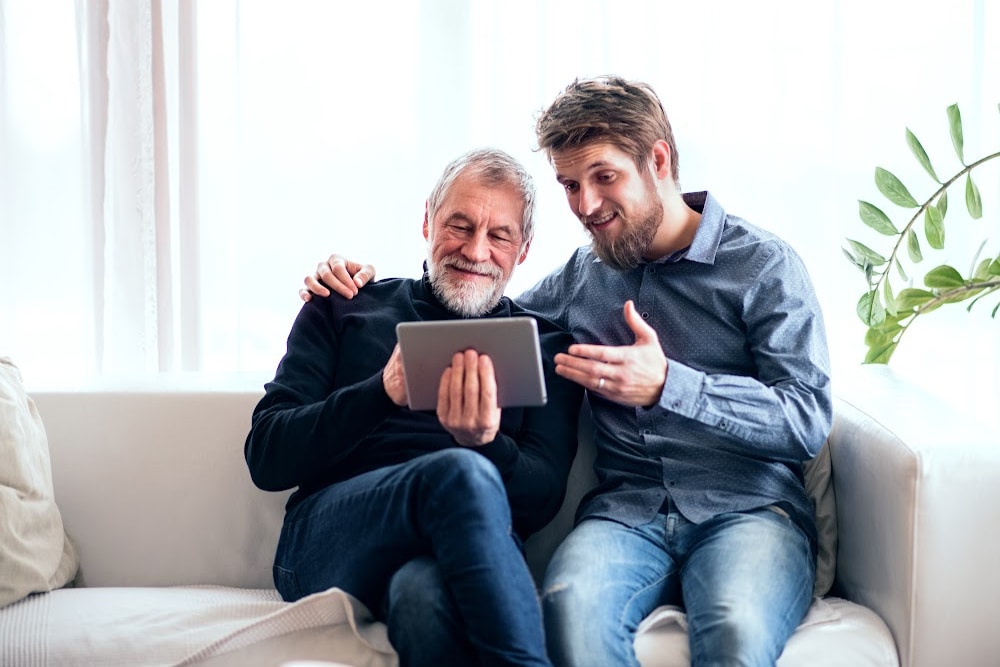 Man over 30 and his elderly father on a tablet