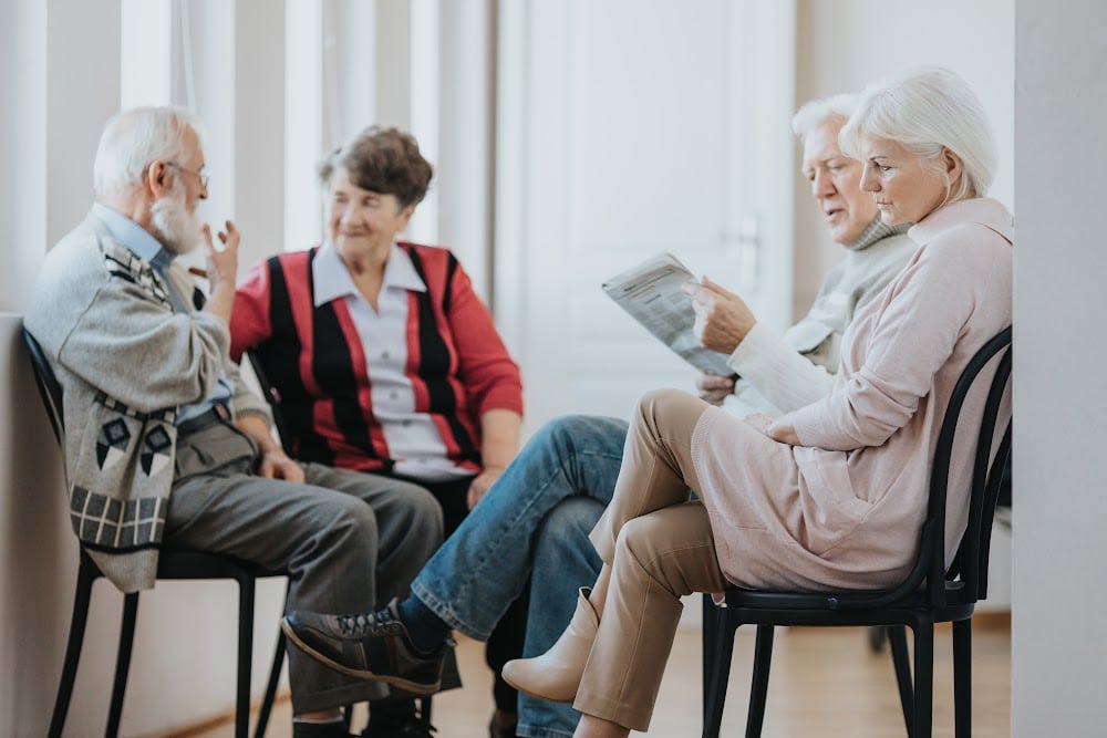 people over 50 sitting in chairs in a circle