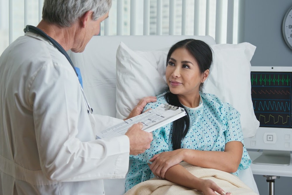 a woman over 40 talking with a doctor in the hospital about fears before surgery