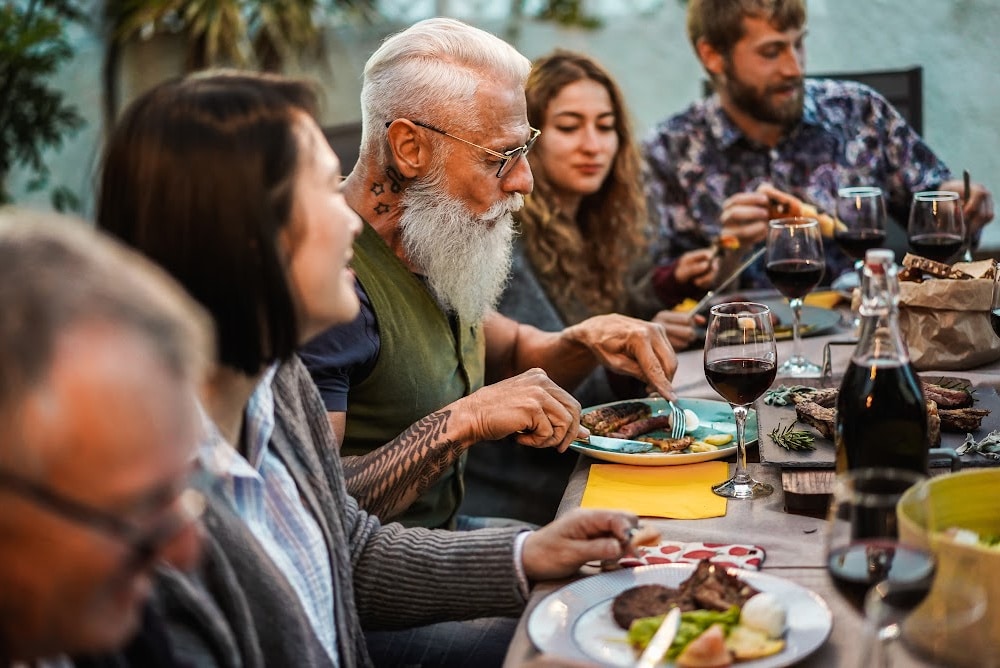 dinner party with people of all ages laughing and eating