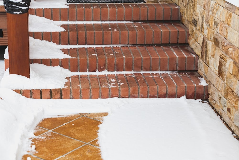 brick stairs with snow on the side
