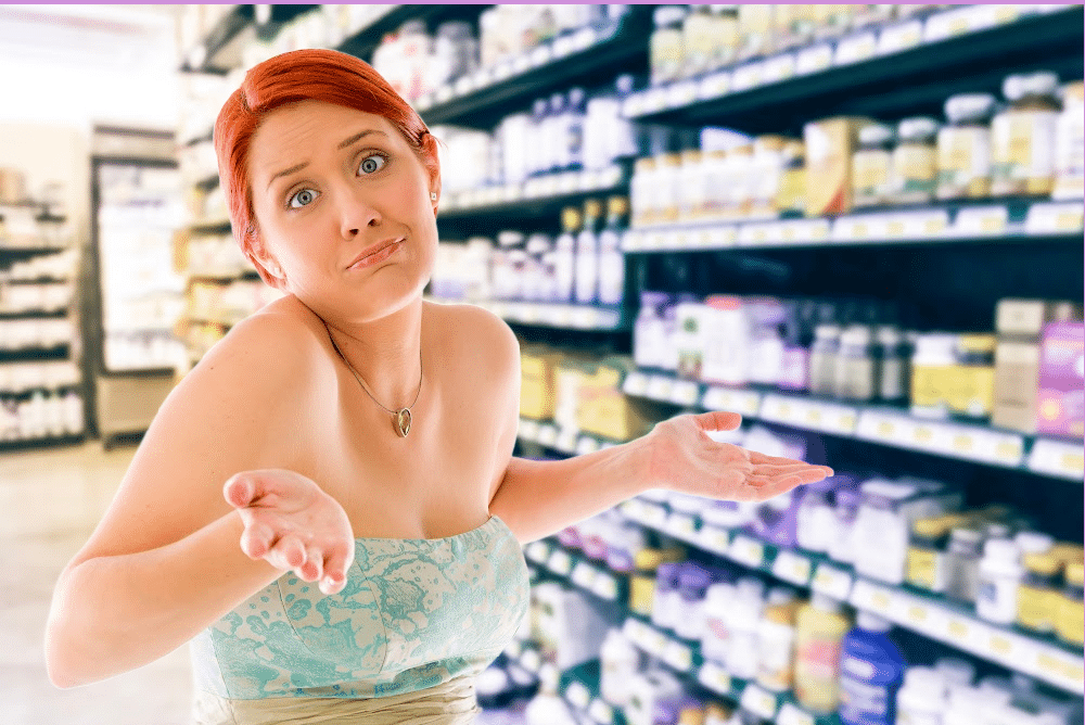 woman with her hands up in a drug store trying to decide which magnesium supplement is right for her.